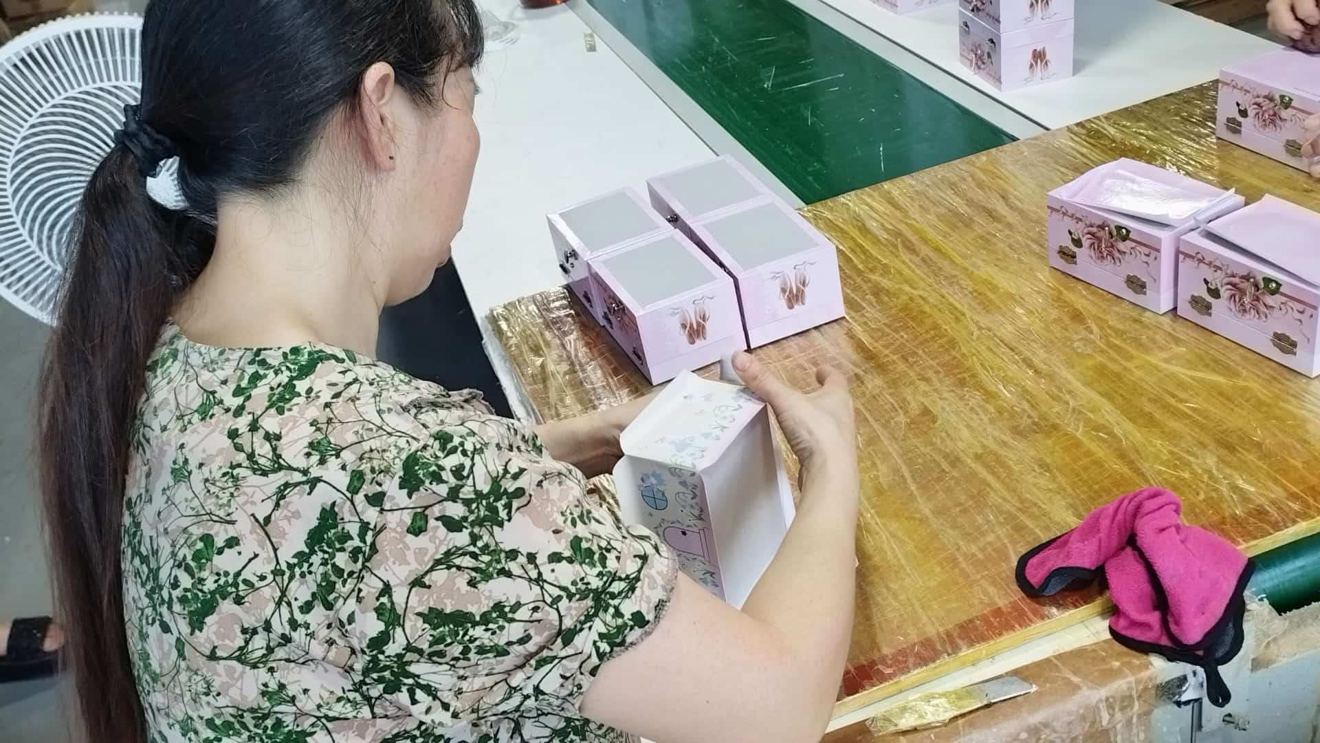 Ever Bright worker finishing the printed paper surface of wrapped MDF boxes